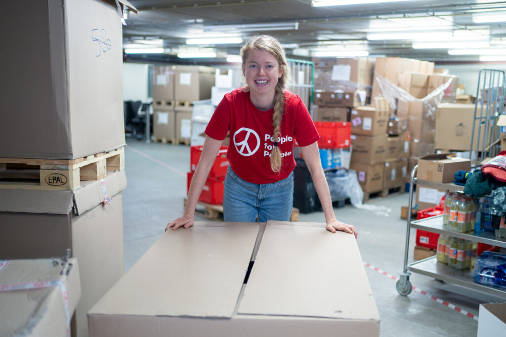 In the People for People warehouse packing boxes of winter clothing for Ukraine.