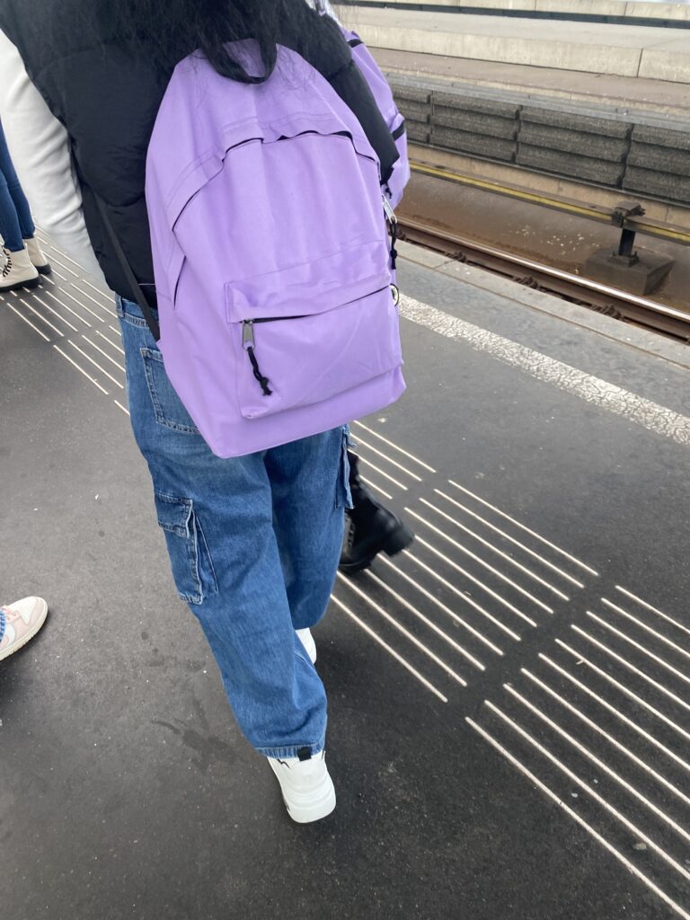 A girl wearing one of our backpacks on her way to school