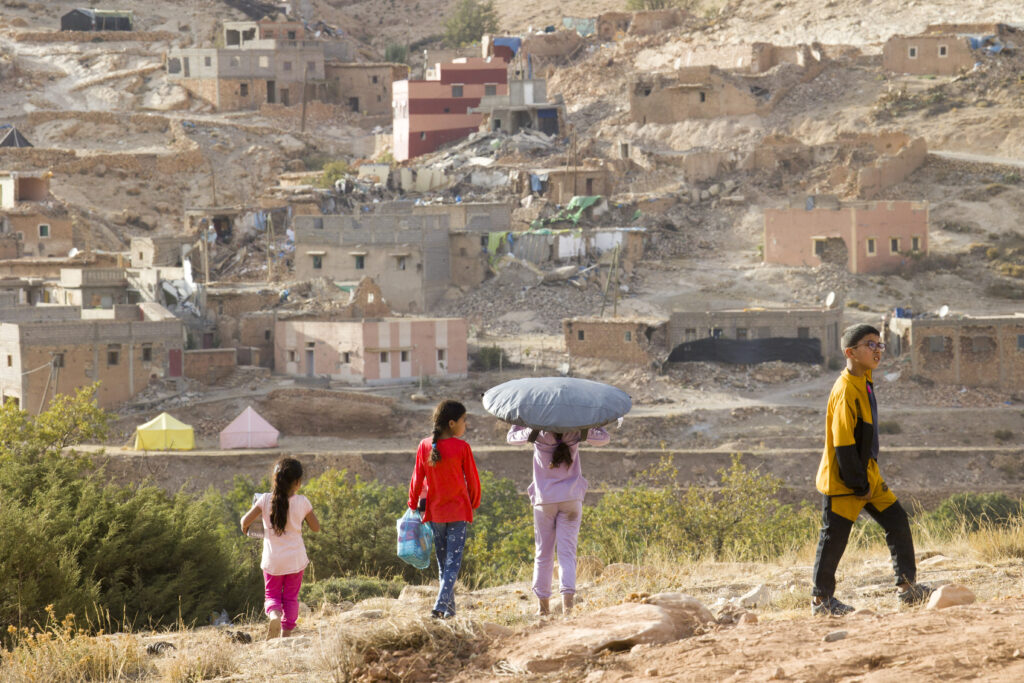 Girls receiving aid during People for People's 2023 mission to Morocco