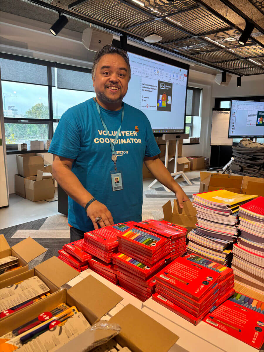 Robin, Amazon volunteer, packs schoolbags for migrant children