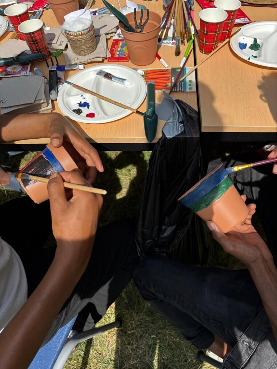 Boys paint plant pots in Driehuis